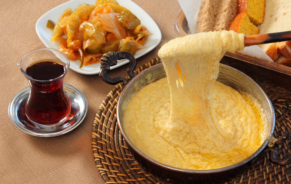 Authentic Black Sea breakfast featuring hot traditional kuymak (muhlama) and Turkish tea