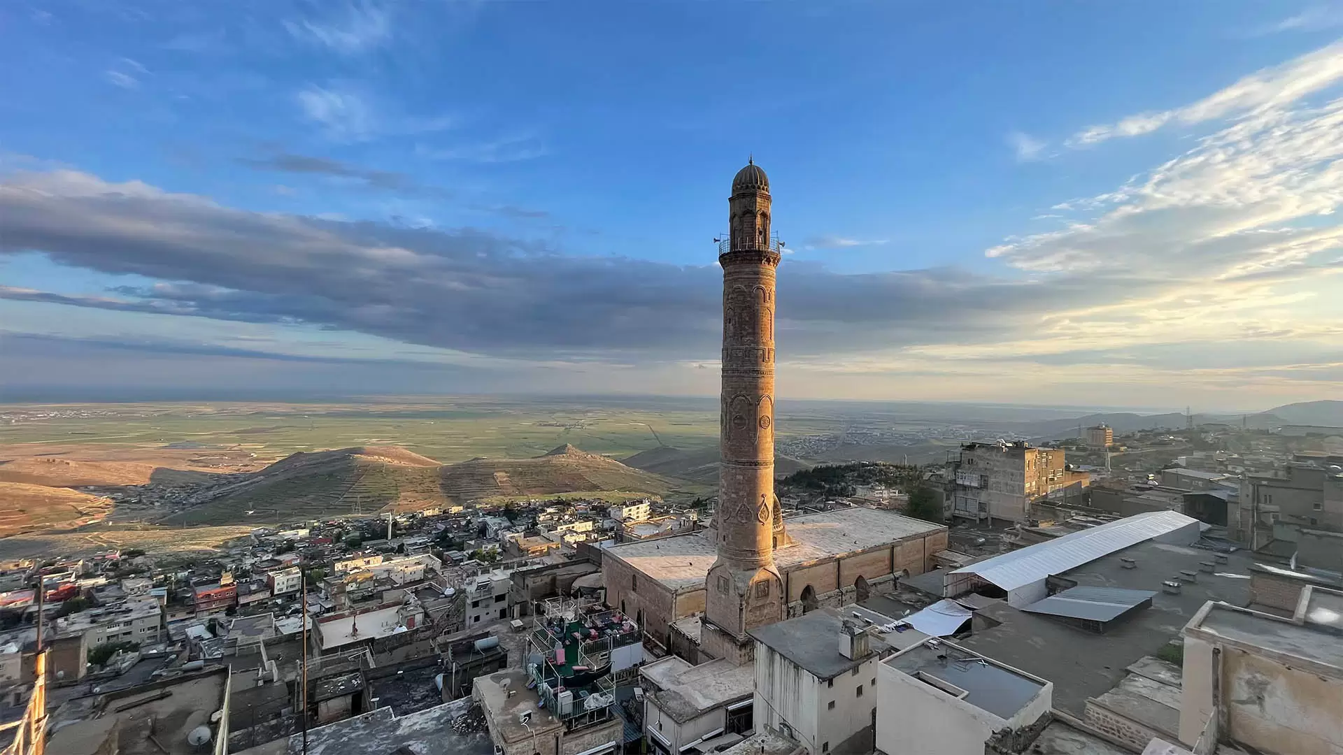 Historic carved minaret of Mardin Grand Mosque with panoramic views of Mesopotamia
